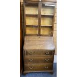 VINTAGE OAK BUREAU BOOKCASE having twin glazed doors over a pigeon hole interior and fall front with