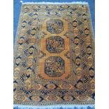 A MUSTARD COLOURED WOOLLEN RUG with tasselled ends, 200 x 143cms