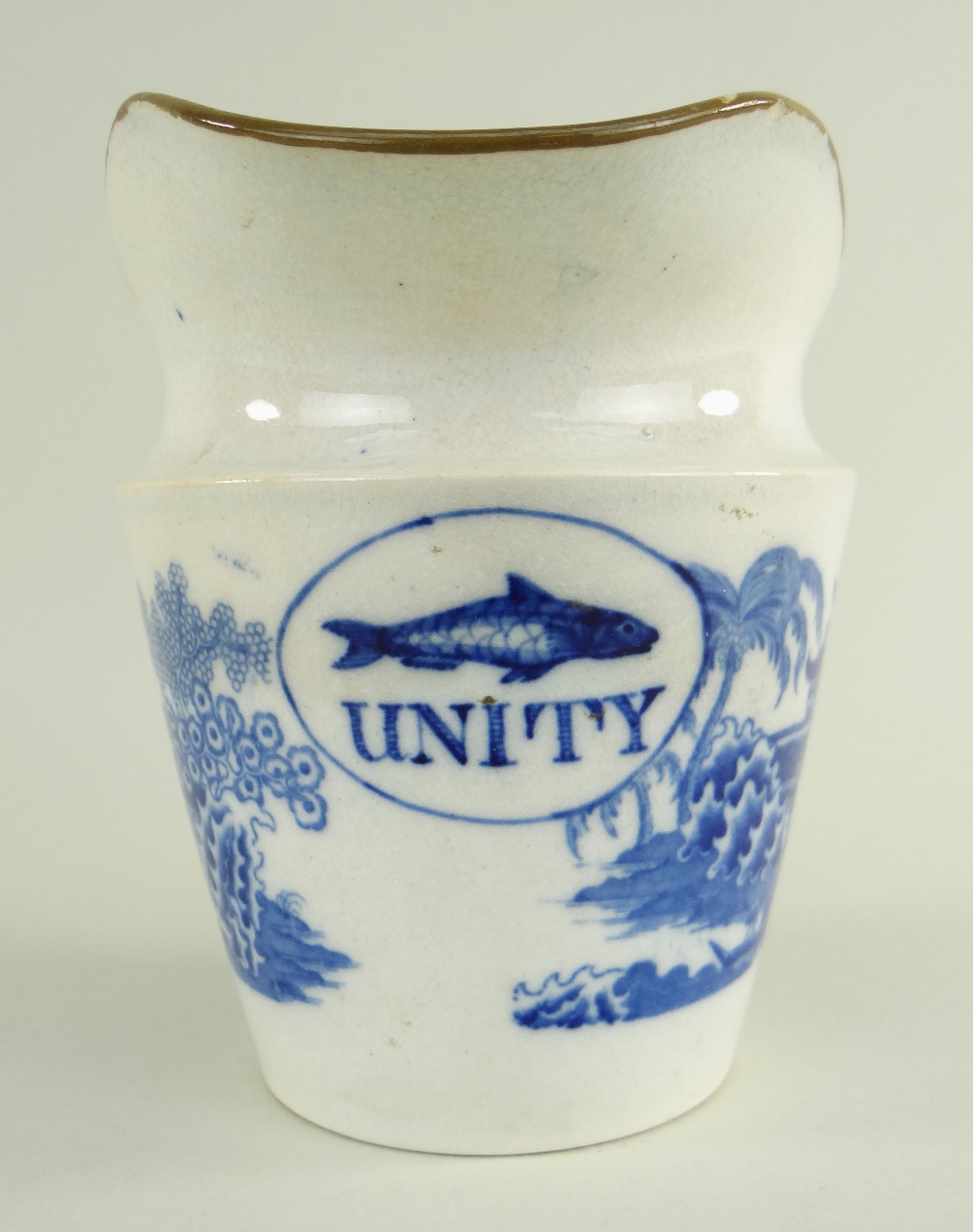 AN EARLY SWANSEA EARTHENWARE UNITY MILK JUG having a tapered body, wide elongated spout and ear-