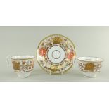 A SWANSEA PORCELAIN JAPAN PATTERN TRIO the two cups with curvaceous ogee handles, decorated with a