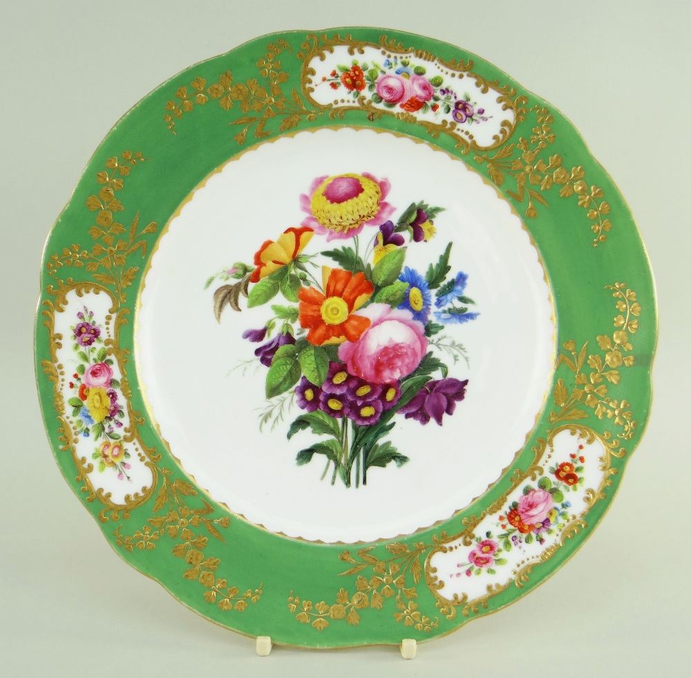 A NANTGARW PORCELAIN PLATE DECORATED IN THE SEVRES STYLE of shaped circular form and having an apple