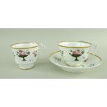 A SWANSEA PORCELAIN TRIO attributed to William Billingsley, painted with pink rose sprigs resting on