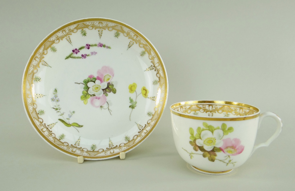 A SWANSEA PORCELAIN CUP & SAUCER the cup with ear-shaped loop handle, locally decorated with flowers