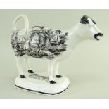 A GLAMORGAN POTTERY COW CREAMER with tail as loop handle, standing on a naturalistic oval base,