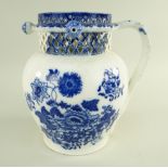 A GLAMORGAN EARTHENWARE PUZZLE JUG IN THE CHRYSANTHEMUM TRANSFER PATTERN of bellied form with loop