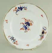 A NANTGARW PLATE of shaped circular form, having solid gilt rim around gilt, cobalt-blue and rust