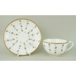 A NANTGARW PORCELAIN CUP & SAUCER decorated with scattered cornflower motifs within a solid gilt