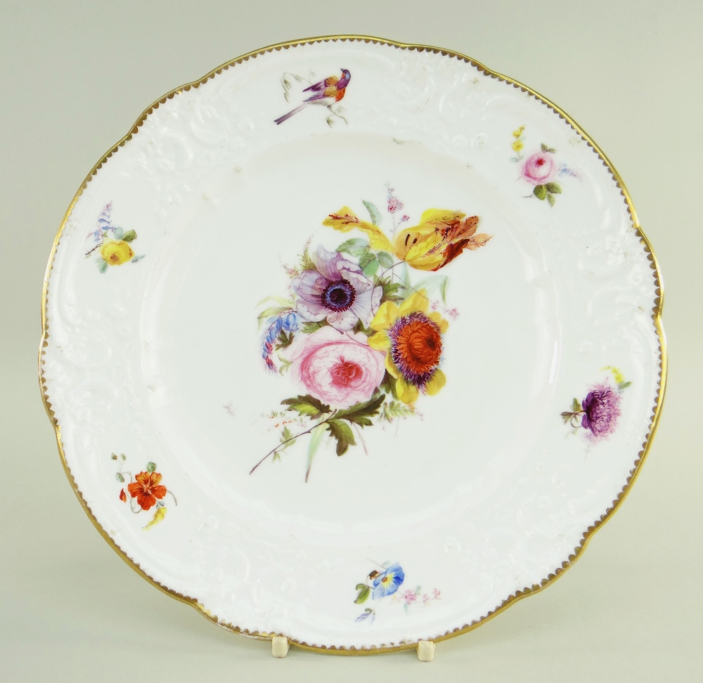 A NANTGARW PORCELAIN PLATE of lobed form, the border moulded with c-scrolls, flowers and tied