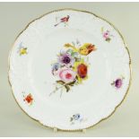 A NANTGARW PORCELAIN PLATE of lobed form, the border moulded with c-scrolls, flowers and tied