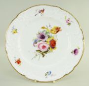 A NANTGARW PORCELAIN PLATE of lobed form, the border moulded with c-scrolls, flowers and tied