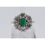 18CT GOLD EMERALD & DIAMOND CLUSTER RING, the central emerald (0.5 x 0.5cms) surrounded by six