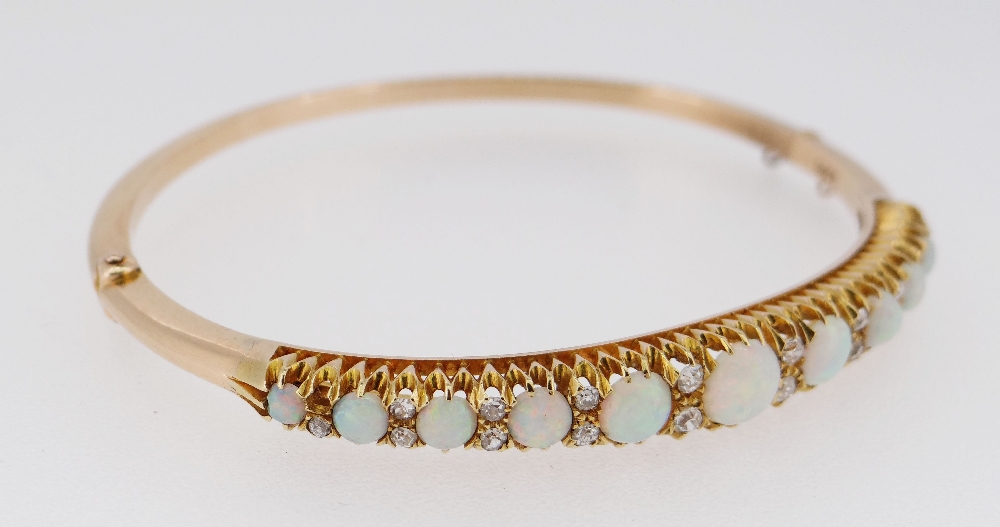 15CT GOLD OPAL & DIAMOND BANGLE, the eleven graduating opals alternating with graduating pairs of - Image 3 of 6