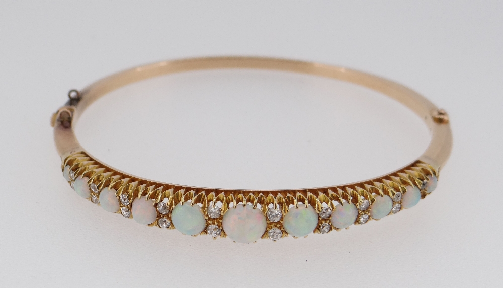 15CT GOLD OPAL & DIAMOND BANGLE, the eleven graduating opals alternating with graduating pairs of - Image 2 of 6