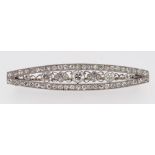 WHITE METAL ART DECO DIAMOND BAR BROOCH, the tapering boat shaped design encrusted with diamonds,