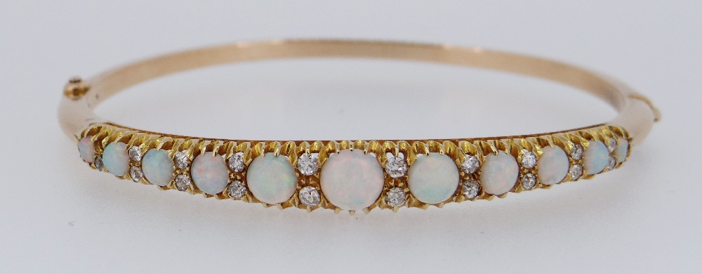 15CT GOLD OPAL & DIAMOND BANGLE, the eleven graduating opals alternating with graduating pairs of - Image 6 of 6