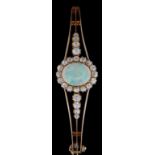 LADIES YELLOW GOLD OPAL & DIAMOND CLUSTER BANGLE, the central opal (11mm x 9mm) surrounded by