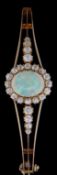 LADIES YELLOW GOLD OPAL & DIAMOND CLUSTER BANGLE, the central opal (11mm x 9mm) surrounded by