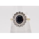 18CT (750) GOLD SAPPHIRE & DIAMOND CLUSTER RING, the central sapphire (0.9 x 0.7cms) surrounded by
