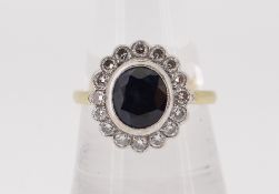 18CT (750) GOLD SAPPHIRE & DIAMOND CLUSTER RING, the central sapphire (0.9 x 0.7cms) surrounded by