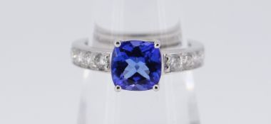 18CT (750) WHITE GOLD TANZANITE & DIAMOND RING, the cushion cut tanzanite (1.61ct approximately) set