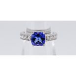 18CT (750) WHITE GOLD TANZANITE & DIAMOND RING, the cushion cut tanzanite (1.61ct approximately) set