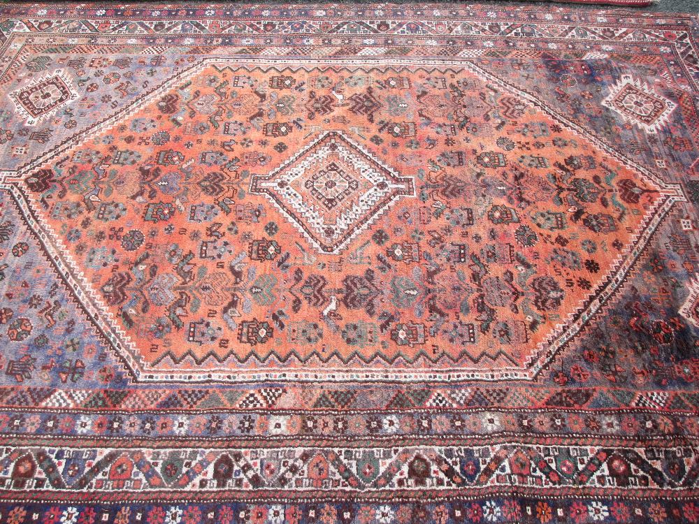 IRANIAN SHIRAZ CARPET tonal reds and blues with busy overall pattern and central block showing