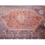 IRANIAN SHIRAZ CARPET tonal reds and blues with busy overall pattern and central block showing