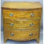 REGENCY CROSSBANDED MAHOGANY BOW FRONT CHEST of three drawers with oval backplates and swing handles