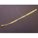 A 9CT GOLD BRACELET of seven narrow bands with clip fastener, 13.9grms