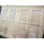 ANTIQUE STRIPPED PINE FOUR DOOR WALL CUPBOARD, open backed with shaped lower detail, 167cms H,