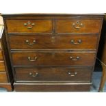 GEORGIAN MAHOGANY CHEST of two short over three long drawers, oak lined with brass pommel and swan