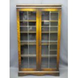 VINTAGE OAK LEADED GLASS TWO DOOR BOOKCASE with interior shelves on a plinth base, 134cms H, 80.5cms