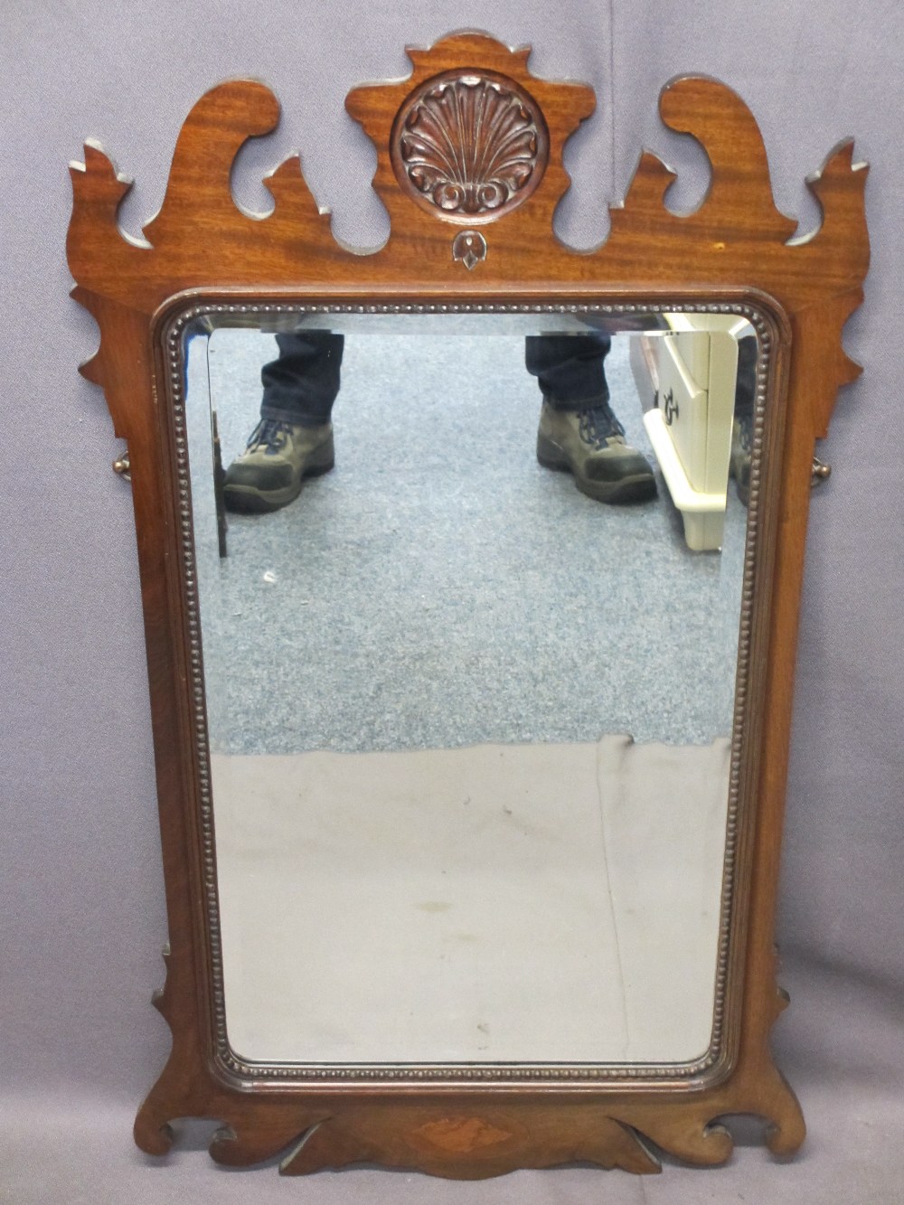 GEORGIAN STYLE REPRODUCTION MAHOGANY WALL MIRROR with shaped and carved detail and bevelled edged