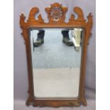 GEORGIAN STYLE REPRODUCTION MAHOGANY WALL MIRROR with shaped and carved detail and bevelled edged
