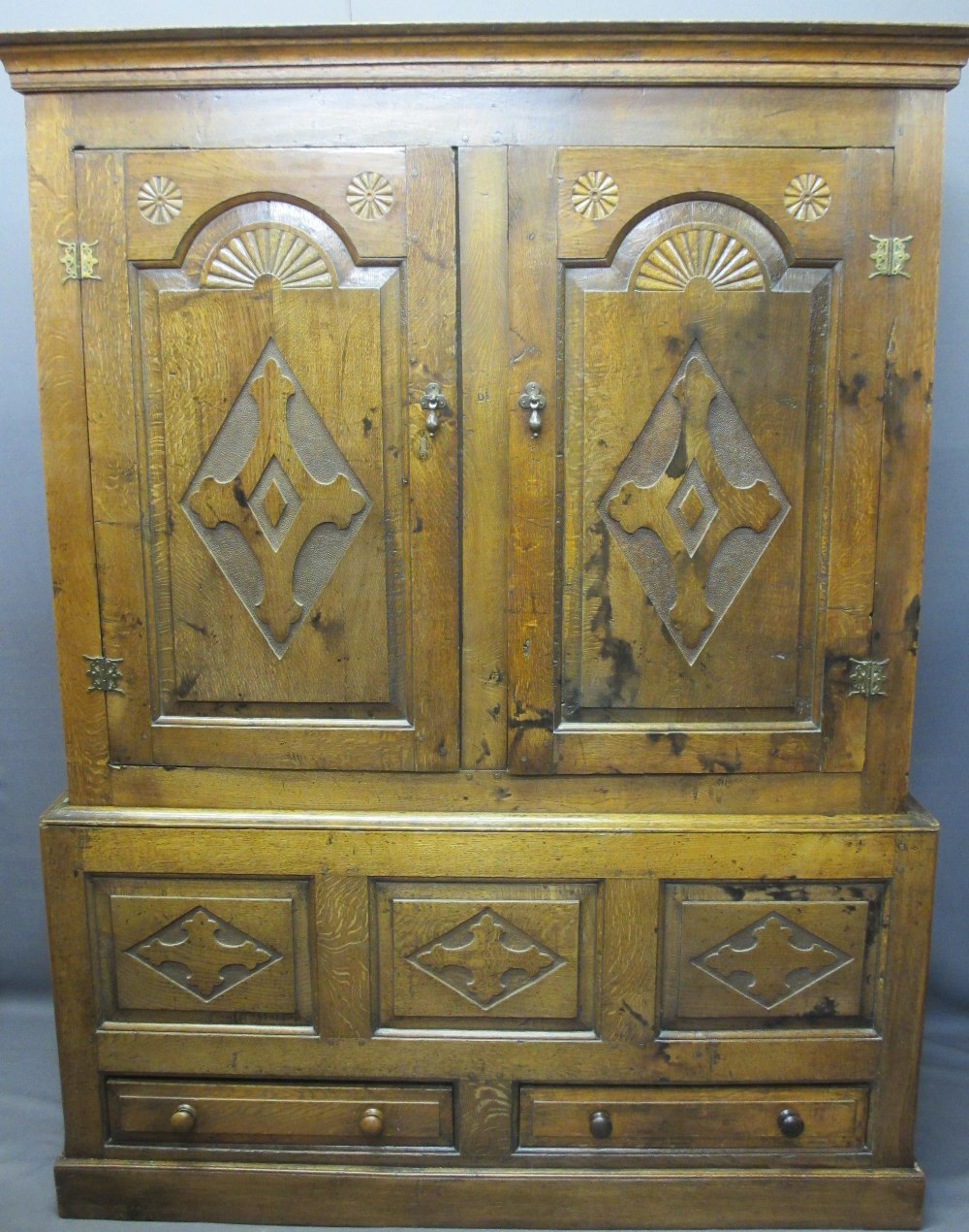 CIRCA 1800 CARVED OAK PRESS CUPBOARD with fan detail and Gothic type crosses on shaped and chamfered