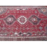 EASTERN WOOLLEN CARPET red ground with traditional central block pattern and multi-bordered