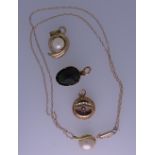 A NECK CHAIN & FOUR PENDANTS - a yellow metal oval link neck chain with yellow metal mounted pearl