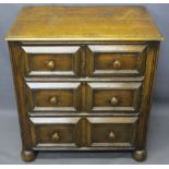 NEAT CONTINENTAL OAK CHEST of two short over two long drawers with reeded front detail on bun