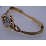 LADY'S 18CT GOLD OMEGA CIRCULAR DIAL WRISTWATCH with eighteen carat gold rope twist twin strand