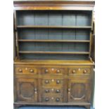 NORTH WALES ANGLESEY OAK DRESSER, CIRCA 1830, the wide boarded back three shelf rack with shaped