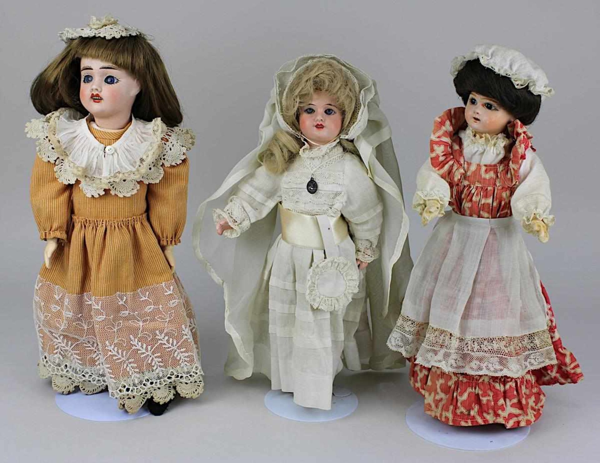 Drei Puppen, meist Frankreich 1. Drittel 20. Jh., Braut oder Kommunionkind mit Porzellankopf mit