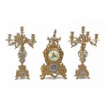 A 19th century French mantel clock garnished with two candelabras in bronze with cloisonné enamel