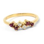 A diamonds and ruby ring with a yellow gold setting