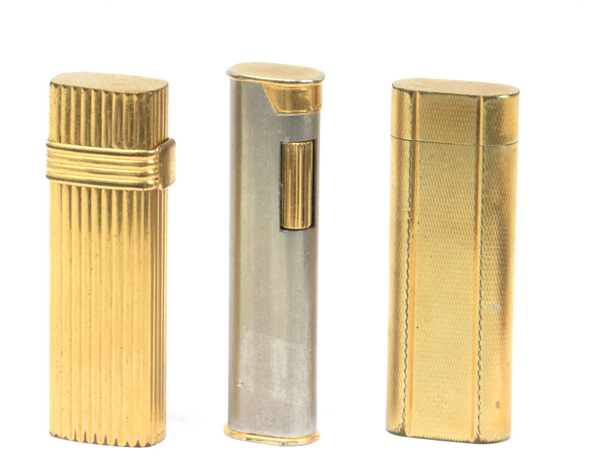 Cartier, Dior & Dunhill. Three gold plated and silver plated lighters