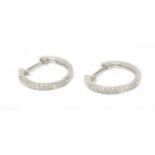 A pair of diamond hoop earrings with an 18k. white gold earrings
