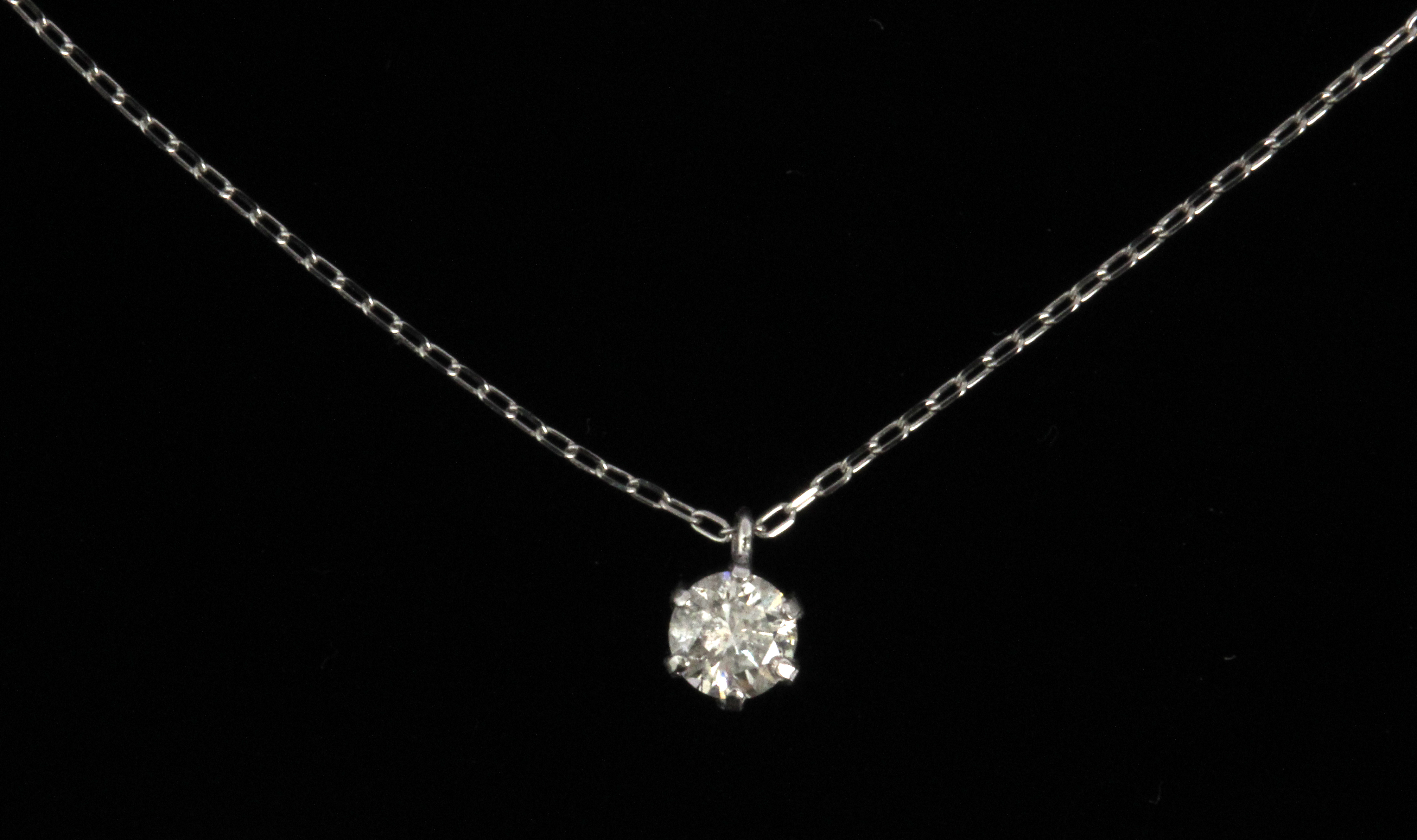 A brilliant cut diamond pendant in a platinum setting