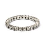 An eternity diamond ring with an 18 k. white gold setting