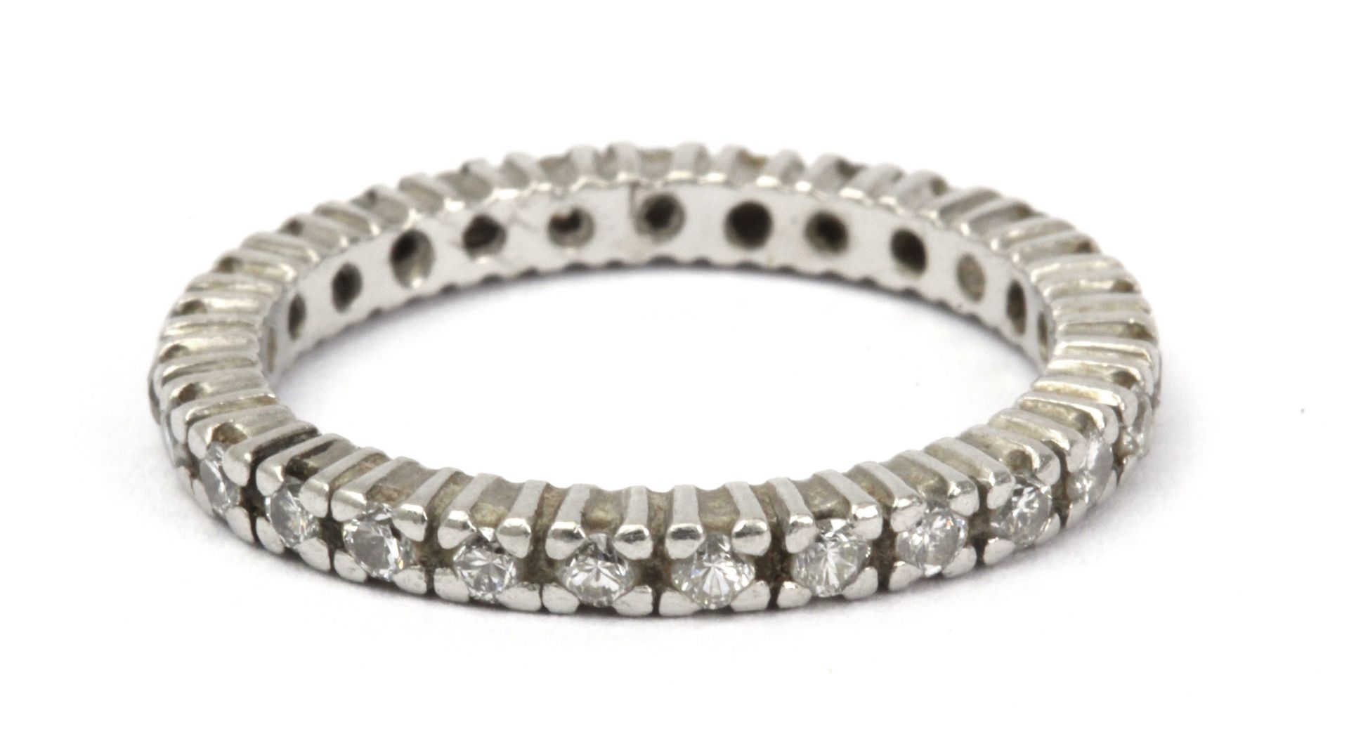 An eternity diamond ring with an 18 k. white gold setting