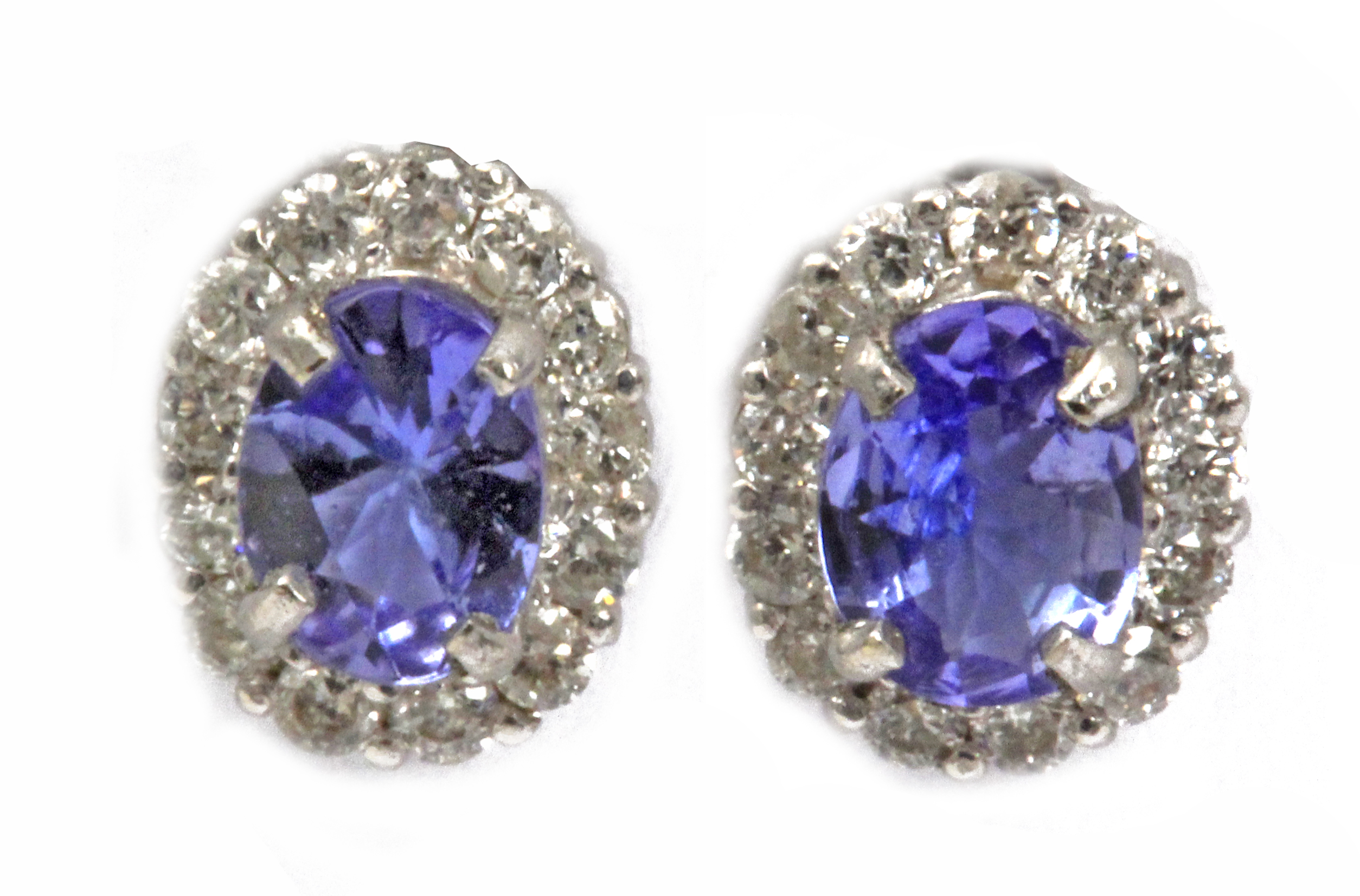 A pair of diamond and tanzanytes cluster earrings in an 18 k. white gold setting