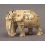 A 19th century Japanese school. A carved ivory okimono depicting a Shibayama style elephant